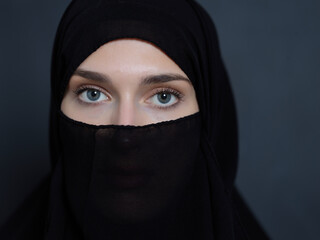 Portrait of muslim woman wearing niqab and traditional arabic clothes or abaya