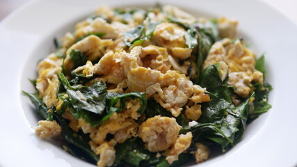 Stir-fried Malindjo leaves ( Bai Lieng) with egg, local vegetables of Southern Thailand.