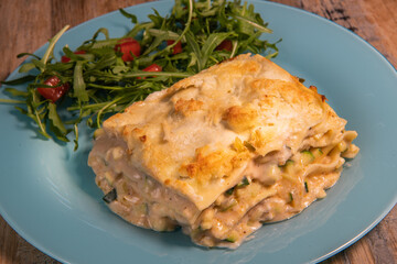Recipe for vegetarian lasagna with goat cheese and arugula. High quality photo
