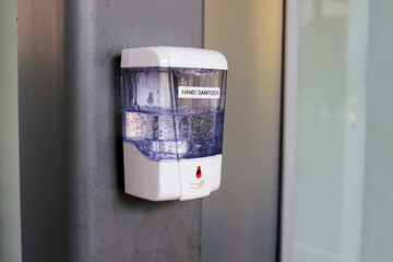Hand sanitizer. Hand sanitizer in a public place against a wall in a public place.
