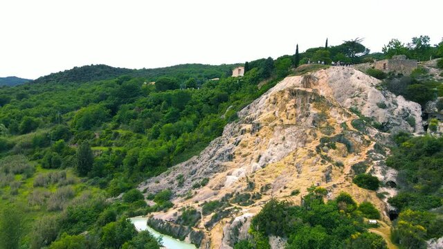 Bagno Vignoni natural pools along the city hill in Tuscany, view in spring season from drone
