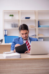 Young attractive employee working in the office