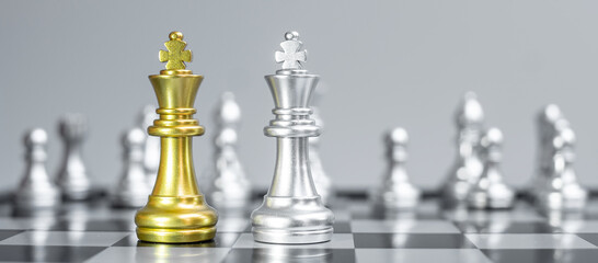 Gold and silver Chess King figure on Chessboard against opponent or enemy. Strategy, Conflict, management, business planning, tactic, politic, communication and leader concept