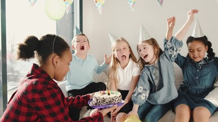 Group of children celebrating birthday party at decorated home