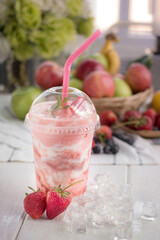Strawberry smoothie and yogurt Strawberry on a wooden plate with ice cubes.