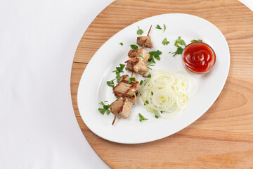 Chicken kebab with hand on white background