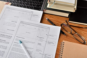 On the desk where I am doing web design. There is a wireframe printable and a pen.