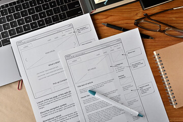 On the desk where I am doing web design. There is a wireframe printable and a pen.