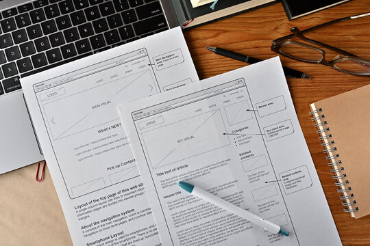 On the desk where I am doing web design. There is a wireframe printable and a pen.