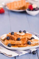 Waffles with blueberries, bananas and honey.