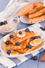 Waffles with blueberries, bananas and honey.
