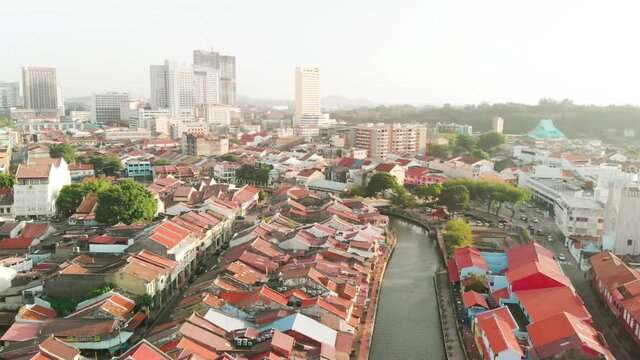Malacca river and skyline on a sunny day, aerial view from drone