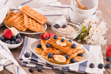 Waffles with blueberries, bananas and honey.
