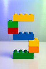 the letter S built from toy brick letters 