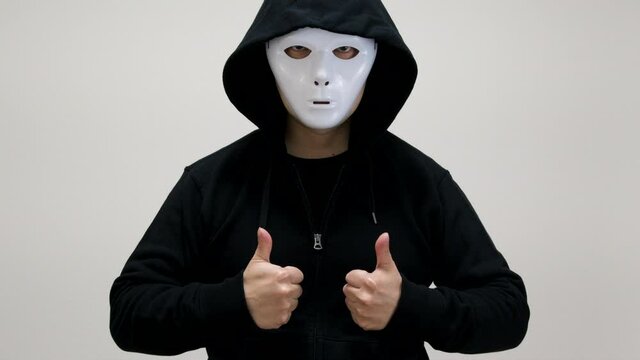 Hacker with anonymous mask showing thumbs up