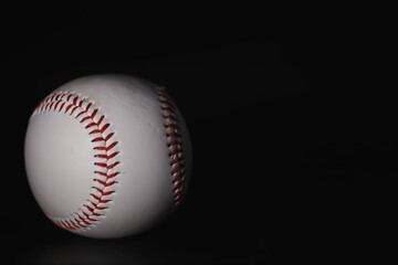 American traditional sports game. Baseball. Concept. Baseball ball and bats on a black table.