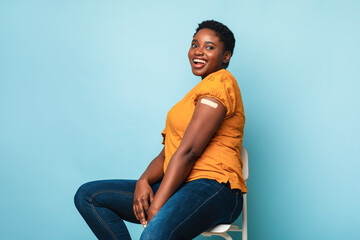 Happy African American Female Showing Vaccinated Arm, Studio Shot