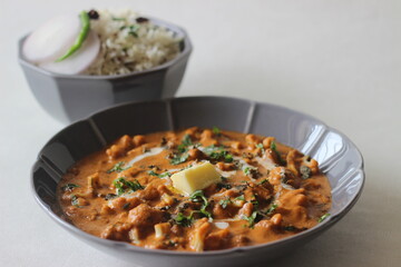 Roasted cauliflower with tomato and cashew sauce. Served as a side dish for cumin flavoured basmati rice