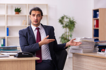 Young male employee unhappy with excessive work