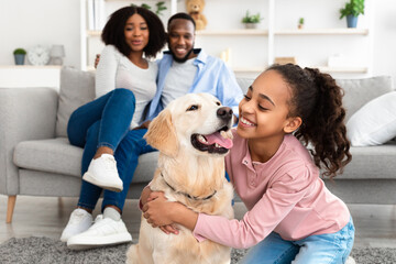 Young black girl hugging dog posing at home - Powered by Adobe