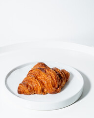 freshly baked croissants on white table