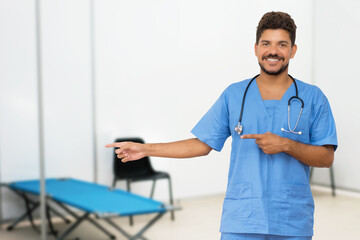 Pointing latin american doctor at vaccination station is ready for vacinating patients