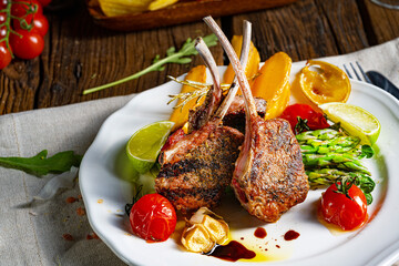 Lamb chops marinated in herbs with green asparagus and lime