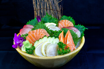 Japanese seafood set consisting of salmon fillet, Scallop , oba leaves, orchid flower, Tuna fillet - obrazy, fototapety, plakaty