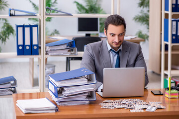 Fototapeta premium Young male sick employee suffering at workplace