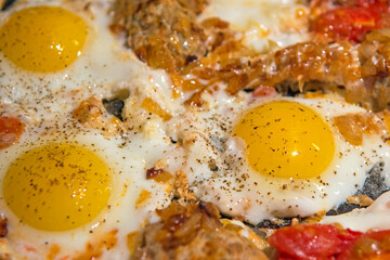 Fried eggs with vegetables and homemade cutlets.  Selective focus. Close up.