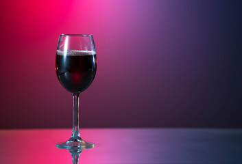 red wine is poured from a bottle into a glass.