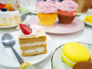 Close up artificial Cake or fake cupcake on white dish with variety  desserts and cake background. dessert. bread. diy food. the most realistic fake foods for display.