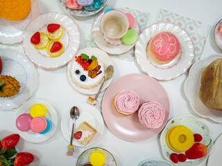 Top view artificial Dessert or fake food with variety desserts as cupcake macaroon cake donut....