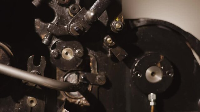 Industrial workshop, old machinery working. Spinning metal gears, retro, rusty machines in slow motion, steampunk scene. Fantasy machines, precision.