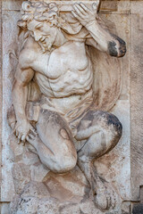 Naklejka premium Ancient sculpture of funny, tricky and joyful dickens in historical downtown of Dresden, Germany, details, closeup. Concept of art and historical heritage.