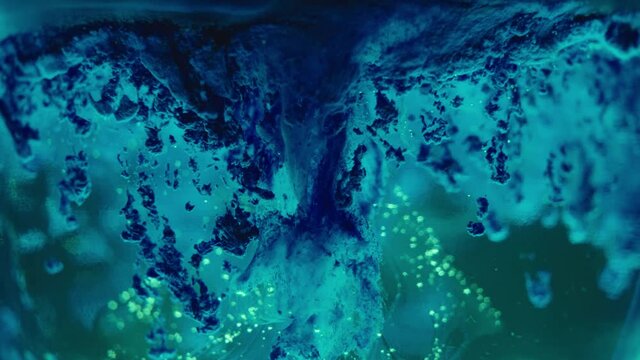 Strange, alien life form. Abstract, moving background, scary, dark backdrop. Weird, colorful liquids in slow motion macro shot.