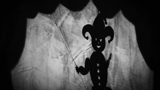 Vintage animation, shadow theatre on a wall. Pantomime, fantasy story. Halloween scene, black and white storytelling. Classic fable for children, creepy puppets.