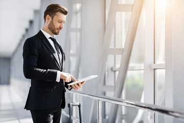Successful entrepreneur with digital tablet in airport