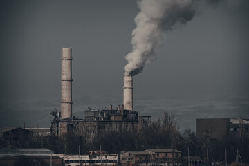 Smoke from the pipes of the plant . Toned