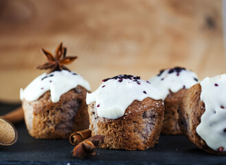 Festive blueberry muffins with white frosting, cinnamon and star anise