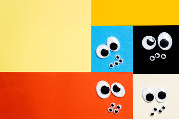 Smileys from toy eyes on hermetic multi-colored background