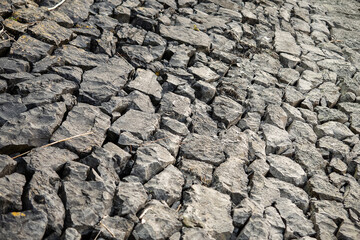 Dry stone surface of a river. Drought season. Nature disaster. Lack of water concept. Nobody.