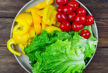 food background ingredients for making summer vegetable salad bell pepper, lettuce and cherry tomatoes, the concept of diet and healthy eating