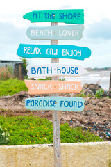 Colorful Wooden sign directions at a beach