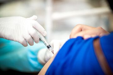 close up of a nurse holding a syringe