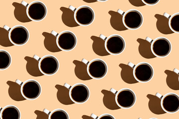A colorful hard light pattern of a coffee cup on beige surface