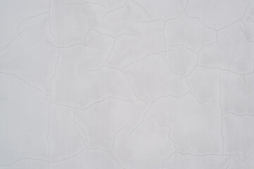 White empty wall with small cracks, close-up Textured surface background. Copy space