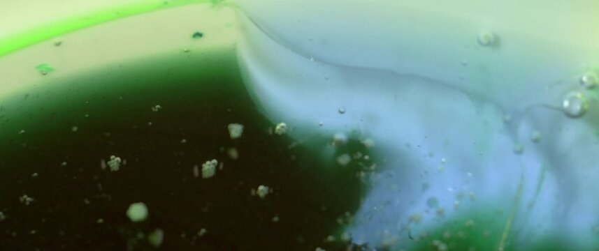 Macro Textures with Vibrant Neon Color Palette. Abstract Background Made with Oil Mixed with Teal and Lime Green Dye, Ink, and Paint.