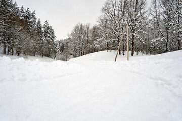 Fototapeta na wymiar Road covered with snow near the forest during winter time