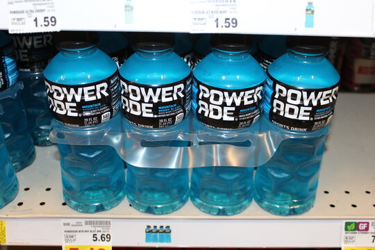 Powerade shot closeup on a metal shelf that's Blue Mountain Berry Blast that's bright and colorful at a Walmart store in Hutchinson Kansas USA.